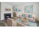 Cozy living room with a fireplace, neutral sofa, stylish decor, and bright natural light at 2315 Selwyn Ave # F, Charlotte, NC 28207