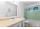 Bathroom features a matching toilet and tub, tiled shower and window at 2328 Danforth Ln, Charlotte, NC 28208