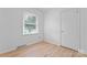 Sunlit bedroom features light wood floors, a window bringing in natural light, and neutral tones at 2328 Danforth Ln, Charlotte, NC 28208