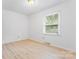 A minimalist bedroom with ample natural light and neutral walls, perfect for creating a relaxing space at 2328 Danforth Ln, Charlotte, NC 28208
