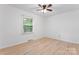 Bright bedroom featuring neutral walls, updated flooring, a ceiling fan, and a sunlit window at 2328 Danforth Ln, Charlotte, NC 28208