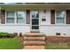 Inviting front entrance with brick steps leading to a screen door at 2328 Danforth Ln, Charlotte, NC 28208