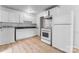 Bright kitchen featuring modern white appliances, ample cabinets and light wood floors at 2328 Danforth Ln, Charlotte, NC 28208