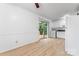 Cozy living room with wood floors, a door and view to the kitchen at 2328 Danforth Ln, Charlotte, NC 28208