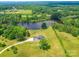 The home is surrounded by lush trees and sits on a large property near a serene lake at 2410 Charlotte Hwy, York, SC 29745