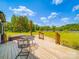 Back deck featuring a dining table, hot tub, lake view and seating for outdoor relaxation and entertainment at 2410 Charlotte Hwy, York, SC 29745