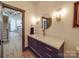 Stylish half-bathroom boasting a modern vanity with marble countertop, gold faucet and fixtures, and decorative wall sconces at 2410 Charlotte Hwy, York, SC 29745