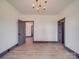 Spacious bedroom featuring an elegant chandelier, wood floors, and neutral wall paint at 2410 Charlotte Hwy, York, SC 29745