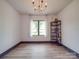 Bright bedroom with a modern light fixture, large window and stylish bookshelf at 2410 Charlotte Hwy, York, SC 29745
