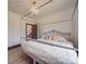 Cozy bedroom featuring a four-poster bed, hardwood floors, and a stylish chandelier at 2410 Charlotte Hwy, York, SC 29745