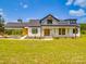 Stunning two-story modern farmhouse features a large front yard and a welcoming covered entry at 2410 Charlotte Hwy, York, SC 29745