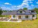 Beautiful two-story farmhouse with white siding, black trim, inviting front porch and attached carport at 2410 Charlotte Hwy, York, SC 29745