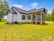 Rear exterior of the home, showing the screened porch and backyard, creating a peaceful living experience at 2410 Charlotte Hwy, York, SC 29745