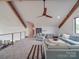 Cozy living room featuring vaulted ceilings, exposed beams, modern furniture, and lots of natural light at 2410 Charlotte Hwy, York, SC 29745