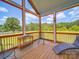 Relaxing screened porch with wood floors, views of the backyard, and seating for enjoying the outdoors at 2410 Charlotte Hwy, York, SC 29745