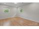 Bright bedroom with hardwood floors and two windows offering ample natural light at 245 Enwood Dr, Charlotte, NC 28214
