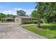 Charming home exterior featuring a covered carport with a picnic table, complemented by a lush front lawn at 245 Enwood Dr, Charlotte, NC 28214