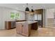 Modern kitchen featuring a large island, stainless steel appliances, and stylish pendant lighting at 245 Enwood Dr, Charlotte, NC 28214