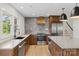 Modern kitchen with stainless steel appliances, quartz countertops, and a stylish tile backsplash at 245 Enwood Dr, Charlotte, NC 28214