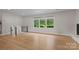 Bright living room with hardwood floors, large windows, and staircase access at 245 Enwood Dr, Charlotte, NC 28214