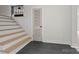 Staircase with tile landing leads to carpeted stairs and an open rail, offering stylish transition between levels at 245 Enwood Dr, Charlotte, NC 28214
