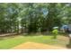 View of a well-maintained backyard with green lawn, mature trees and a wood deck at 2592 Tully Ct # 78, Lancaster, SC 29720