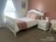 Cozy bedroom featuring a white bed frame, pink accents, and natural light from the window at 2592 Tully Ct # 78, Lancaster, SC 29720