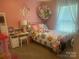 Pink bedroom with colorful accents, a desk, and lots of stuffed animals at 2592 Tully Ct # 78, Lancaster, SC 29720