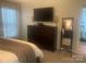 Spacious bedroom offering a dresser with TV, decorative mirror, and plenty of natural light at 2592 Tully Ct # 78, Lancaster, SC 29720