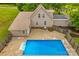 Aerial view of backyard in-ground pool, spacious yard, and a charming two-story home at 296 Hicks Creek Rd, Troutman, NC 28166