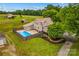 Aerial view of a home with a fenced in backyard with an inground pool, metal roof and wooded landscape at 296 Hicks Creek Rd, Troutman, NC 28166