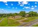 Aerial view of property showcasing a winding driveway and a sprawling yard and outbuilding, offering privacy and space at 296 Hicks Creek Rd, Troutman, NC 28166