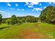 Expansive backyard offering ample green space and a serene environment, ideal for outdoor recreation and relaxation at 296 Hicks Creek Rd, Troutman, NC 28166