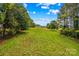 Overlooking a large backyard with mature trees, the landscape offers a private and serene outdoor area at 296 Hicks Creek Rd, Troutman, NC 28166