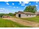 Exterior view of barn with concrete walls and multiple windows on a well-maintained grassy lot at 296 Hicks Creek Rd, Troutman, NC 28166