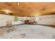 Interior view of large barn with concrete floor and plywood ceiling with hanging lights at 296 Hicks Creek Rd, Troutman, NC 28166