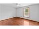 Bright bedroom featuring hardwood floors, a ceiling fan and a window overlooking the yard at 296 Hicks Creek Rd, Troutman, NC 28166