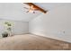 Bedroom features include neutral carpet, a ceiling fan, and a window for natural light at 296 Hicks Creek Rd, Troutman, NC 28166