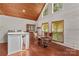Cozy dining room featuring wood floors, wood paneled ceilings and natural light from large windows at 296 Hicks Creek Rd, Troutman, NC 28166