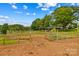 Spacious horse paddock with sturdy wooden fencing and an open gate, perfect for equestrian activities on the property at 296 Hicks Creek Rd, Troutman, NC 28166