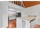 Modern kitchen featuring white cabinets, stainless steel appliances, breakfast bar, and wood floors at 296 Hicks Creek Rd, Troutman, NC 28166