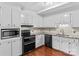 Updated kitchen featuring white cabinets, granite countertops, stainless steel appliances, and hardwood floors at 296 Hicks Creek Rd, Troutman, NC 28166