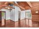 Large living room with wood ceiling, beautiful hardwood floors, and a glass door to the exterior at 296 Hicks Creek Rd, Troutman, NC 28166