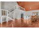 Bright living room featuring an open floor plan, lofted area, wooden floors, and a modern kitchen at 296 Hicks Creek Rd, Troutman, NC 28166