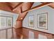 Bright living room with hardwood floors, wood ceilings, and natural light streaming through large windows at 296 Hicks Creek Rd, Troutman, NC 28166