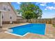Backyard in-ground pool features clear blue water, surrounded by a concrete deck at 296 Hicks Creek Rd, Troutman, NC 28166