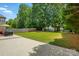 A beautiful backyard with a concrete patio, lush lawn, and privacy fence offers perfect outdoor living at 3005 Streamlet Way, Monroe, NC 28110