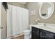 Cozy bathroom featuring a shower with curtain and a vanity with a modern sink and mirror at 3005 Streamlet Way, Monroe, NC 28110