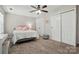 Neutral bedroom showcasing a ceiling fan, carpeted floors, and a double door closet at 3005 Streamlet Way, Monroe, NC 28110
