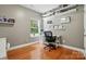 Well-lit bedroom with hardwood floors, window, and shelving unit at 3005 Streamlet Way, Monroe, NC 28110